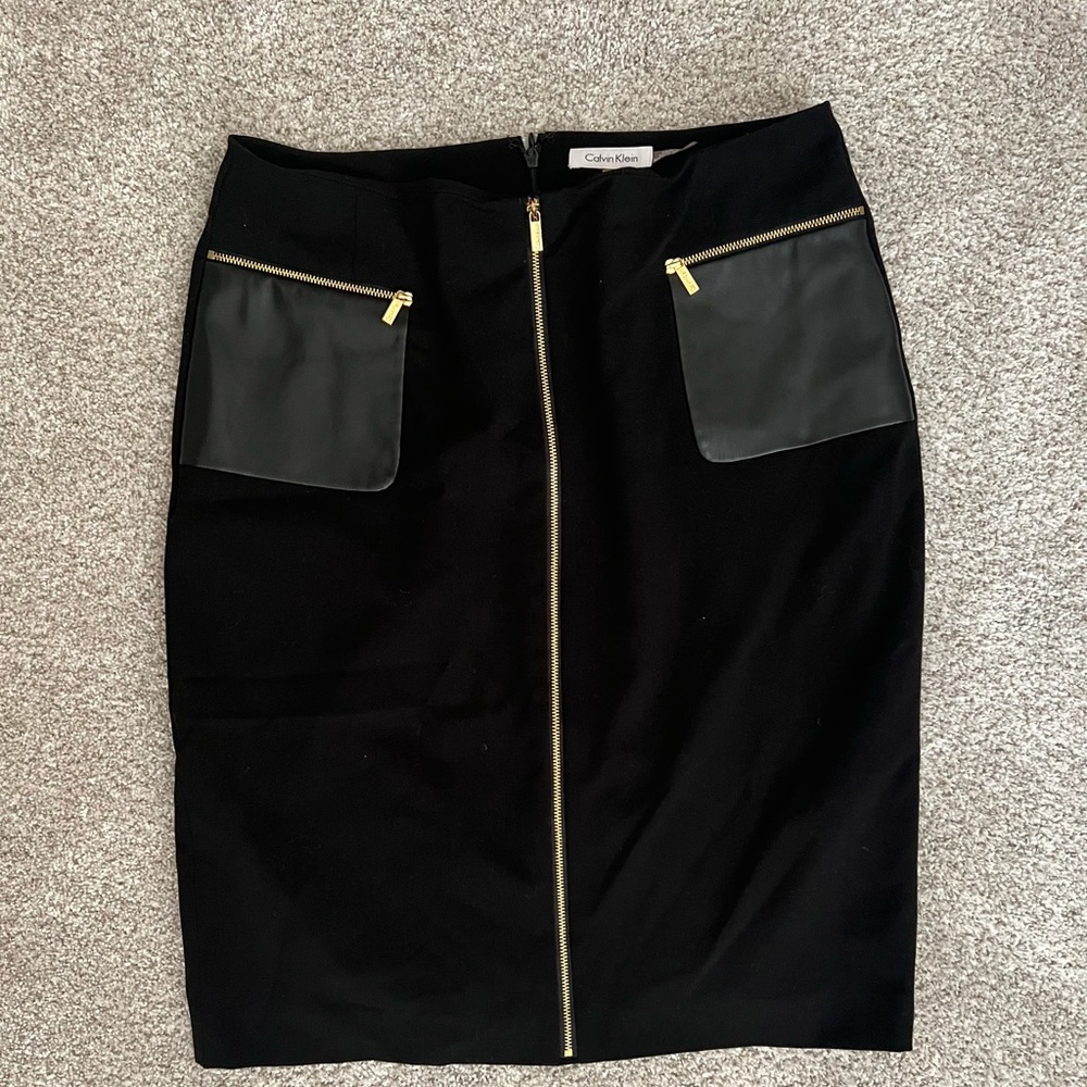 Calvin Klein black skirt, faux leather details. New without tags